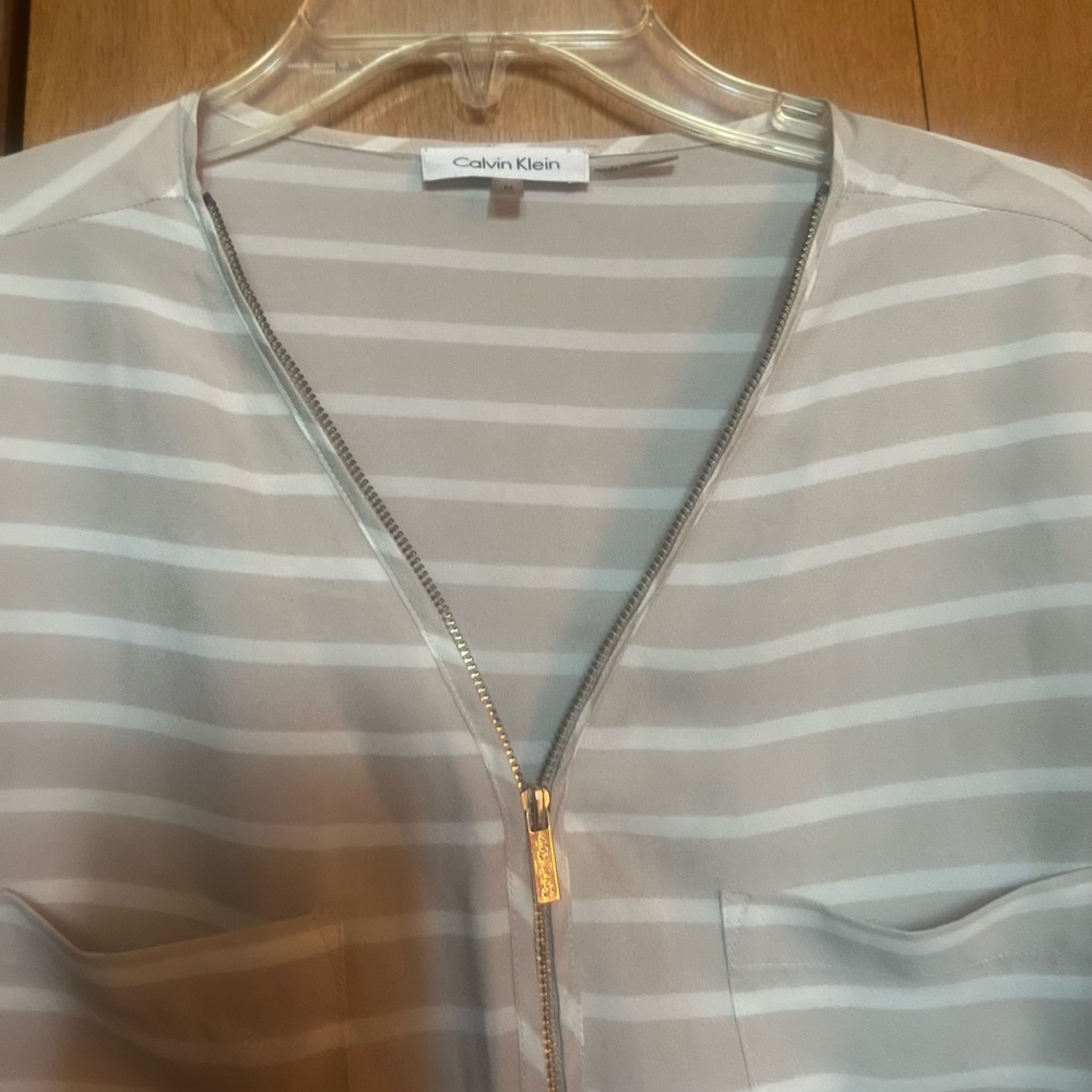 Calvin Klein, size Med, tan and white striped w/gold front zipper blouse.